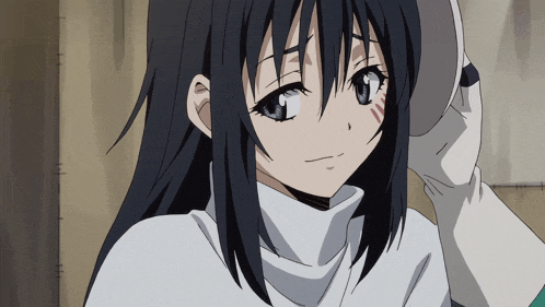 a girl with long black hair and blue eyes is wearing a white sweater