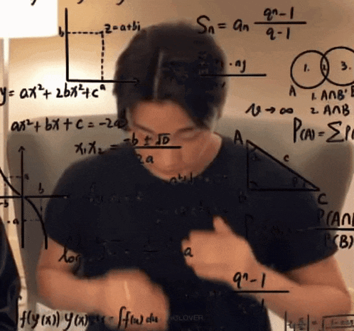 a man is standing in front of a white board with math equations on it