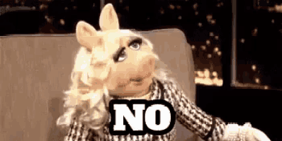 miss piggy from the muppet show is sitting on a couch holding a sign that says `` no '' .