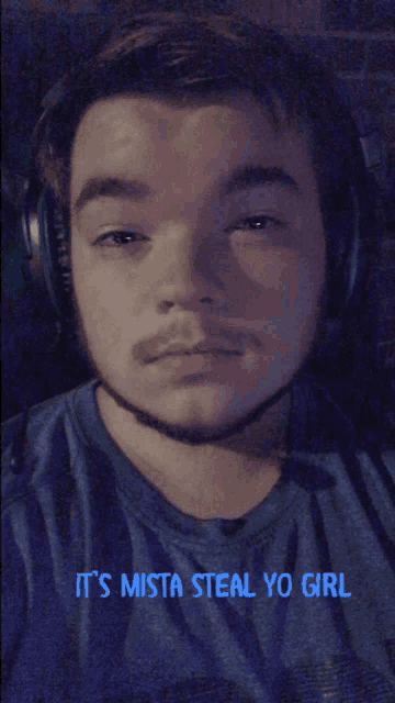 a man wearing headphones and a shirt that says it 's mista steal yo girl on it
