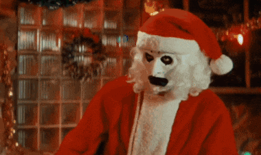 a person dressed as santa claus with a white face