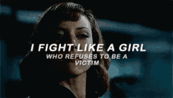 a woman with the words i fight like a girl who refuses to be a victim above her