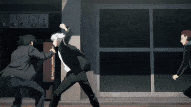 a man in a suit is fighting another man in front of a sign that says ' noodles ' on it