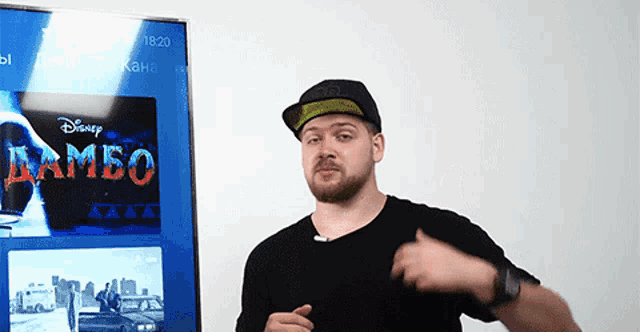 a man is standing in front of a screen that says rambo