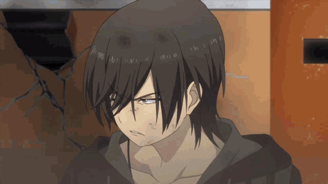 a man with long black hair is looking at the camera with an angry look on his face