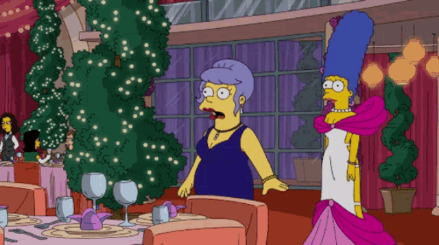 two women are standing in front of a christmas tree in a restaurant