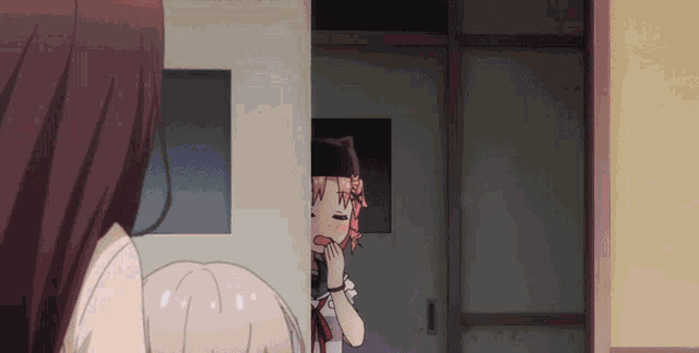 a girl with a cat on her head is standing next to another girl