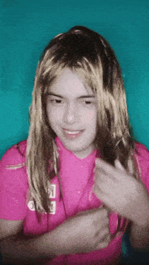 a girl wearing a wig and a pink shirt that says ' i love you ' on it