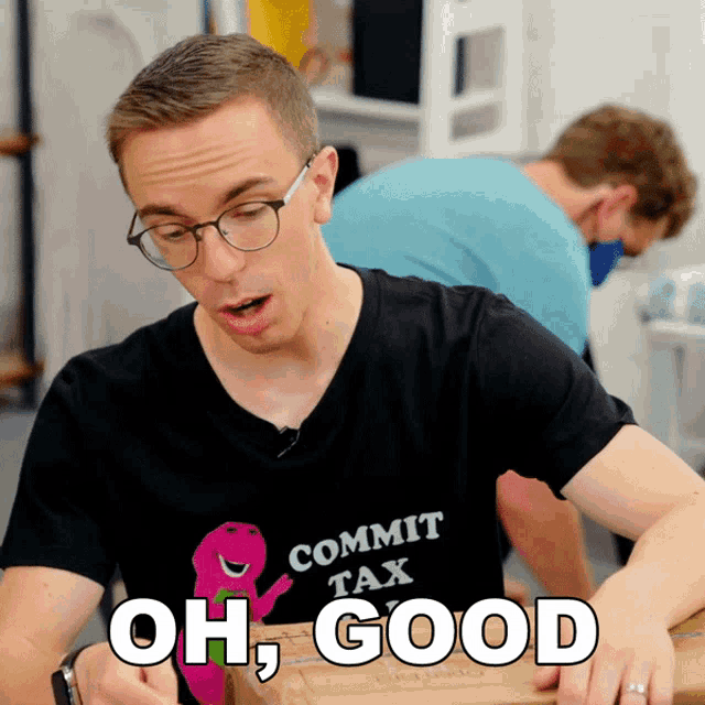a man wearing a black shirt that says commit tax