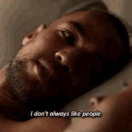a man is laying in bed next to a woman and saying `` i don 't always like people '' .