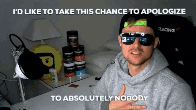 a man wearing sunglasses and a racing hat says i 'd like to take this chance to apologize