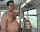 a shirtless man with a tattoo on his arm is standing in a bathroom .