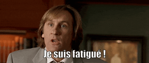 a man in a suit and tie says " je suis fatigué "