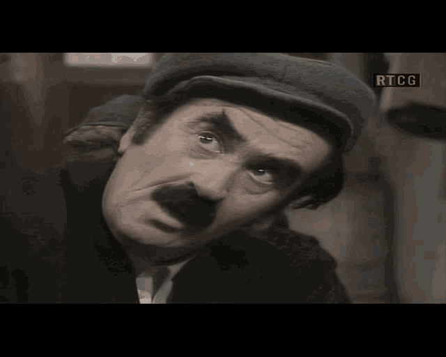 a man with a hat and mustache says ti kad slazeš