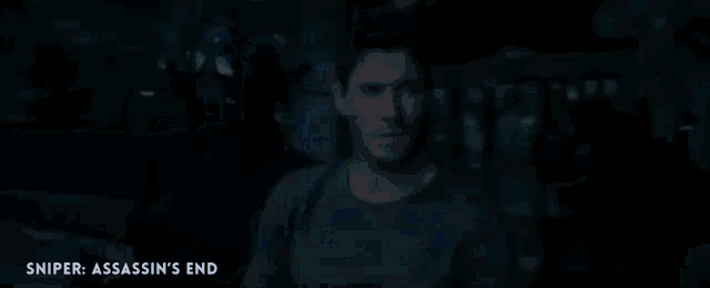 a close up of a man 's face in a dark room