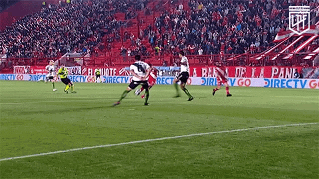 a soccer game is being played in front of a large crowd and a banner that says directv