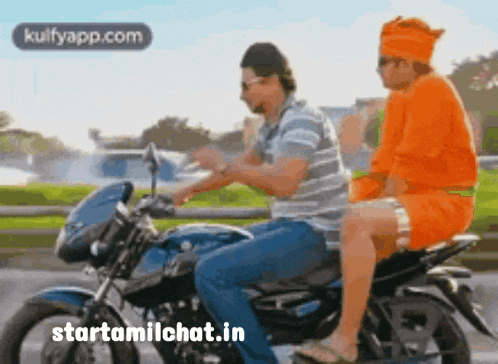 a man and a woman are riding a motorcycle on a road .