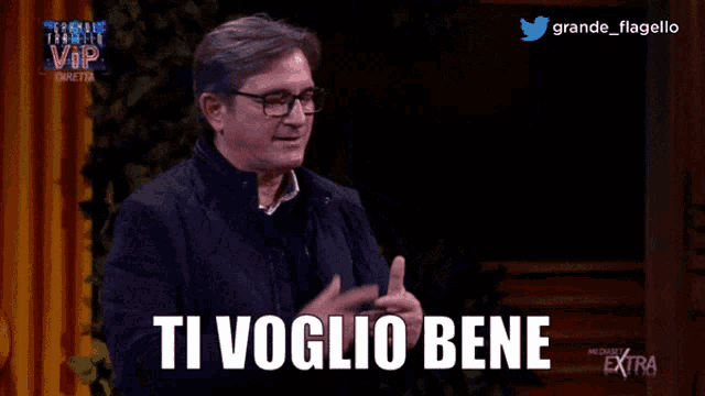 a man with glasses says ti voglio bene on a screen