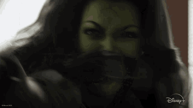 a close up of a woman 's face with a disney + logo in the corner