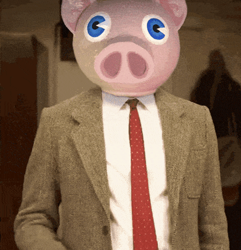 a man wearing a suit and tie with a pink pig head