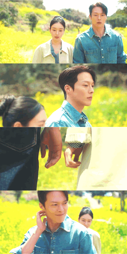 a man and a woman holding hands in a field of yellow flowers