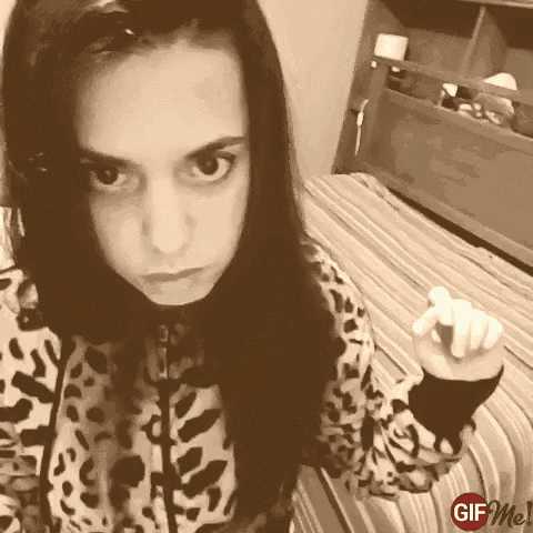 a girl in a leopard print shirt is pointing at the camera