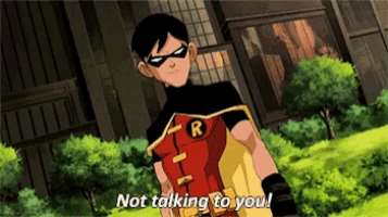 robin is standing in front of a building and says " not talking to you "