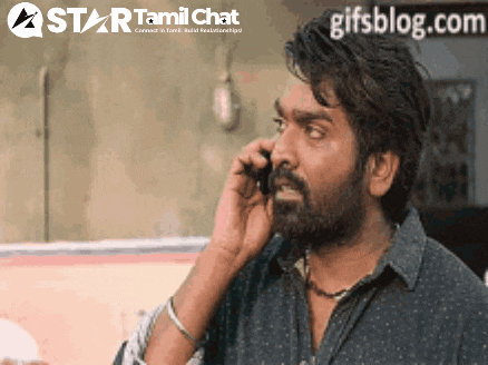 a man with a beard is talking on a cell phone with a star tamil chat logo behind him