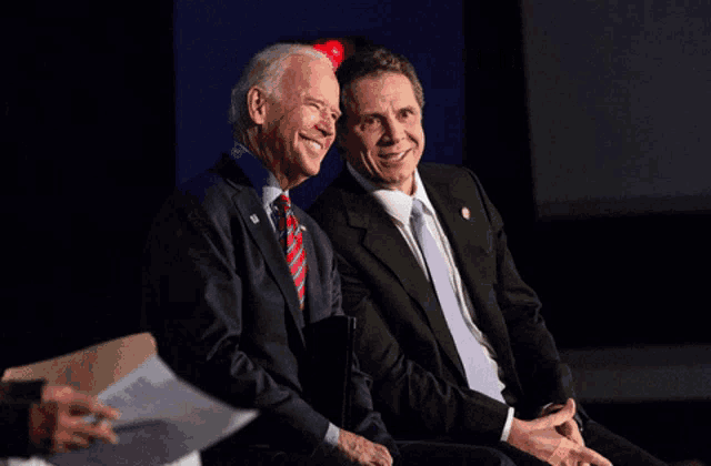 joe biden and andrew cuomo are sitting next to each other with the caption kissing hillary 's ring