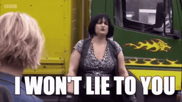 a woman is standing in front of a truck with the words `` i won t lie to you '' written on it .