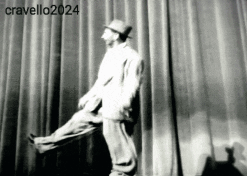 a man in a hat is standing in front of a curtain with the year 2024