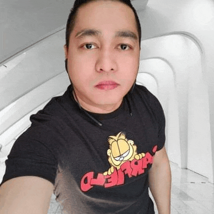 a man is taking a selfie with a garfield shirt on .