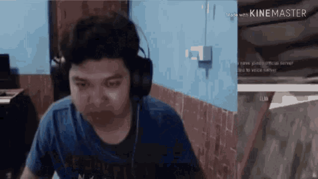 a man wearing headphones is sitting in front of a computer screen that says kinemaster