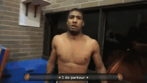 a shirtless man is standing in front of a sign that says ' i do parkour '