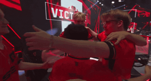 a group of people hugging in front of a sign that says ' victoria '