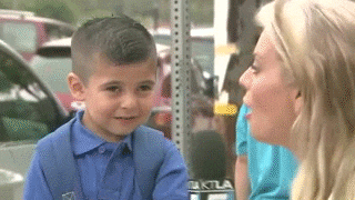 a little boy is being interviewed by a woman with a microphone that says ktla on it