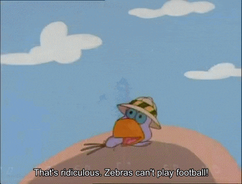 a cartoon character in a green and orange outfit is holding a baby in a sling .