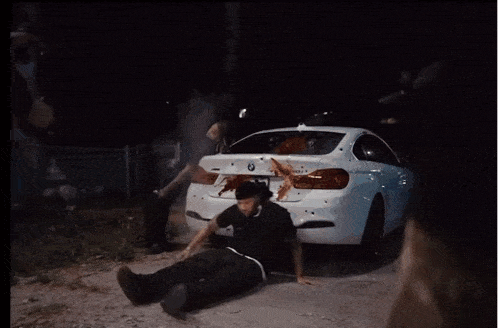a man laying on the ground with a gun in his hand and a badge that says ' a ' on it