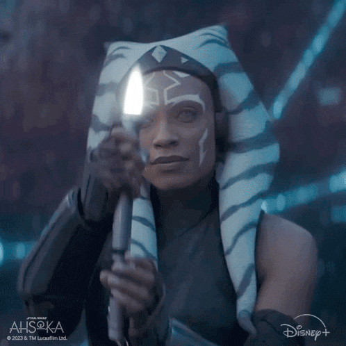ahsoka tano from star wars is holding a lightsaber in her hand