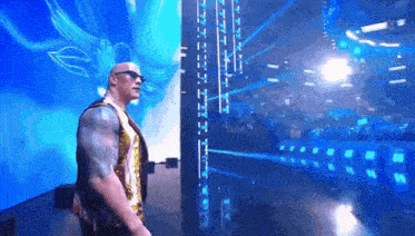 a man wearing sunglasses is standing in front of a large screen that says ' intercontinental heavyweight champion ' on it