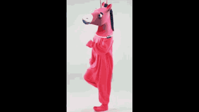 a person in a pink horse costume is walking
