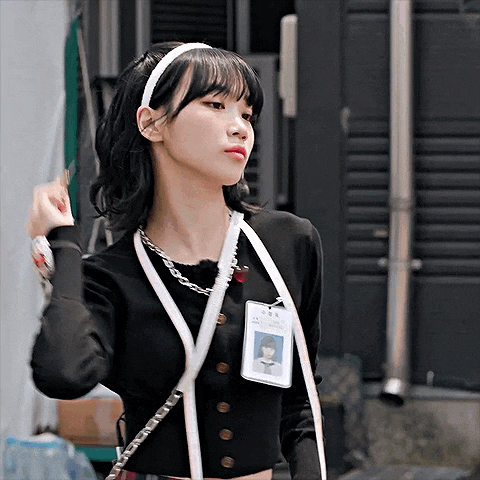 a woman wearing a headband and a lanyard with a name tag that says ' a ' on it