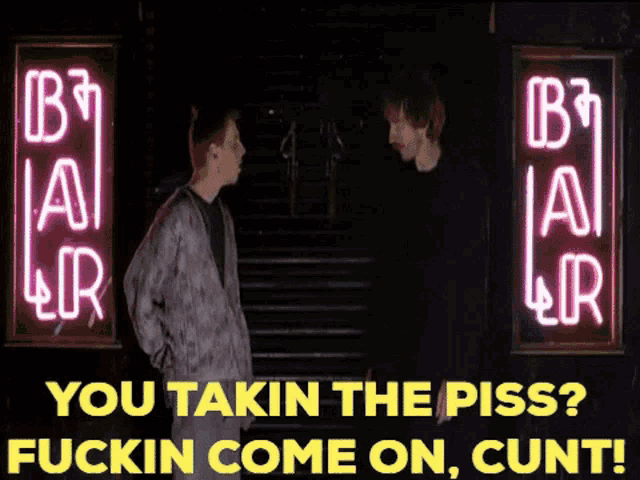 two men standing in front of a neon sign that says b3