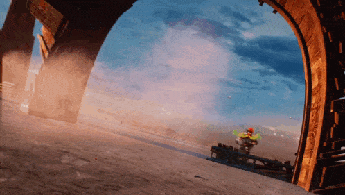 a person riding a bike through a tunnel with a blue sky in the background