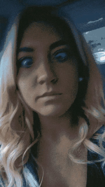 a close up of a woman 's face with a blue background