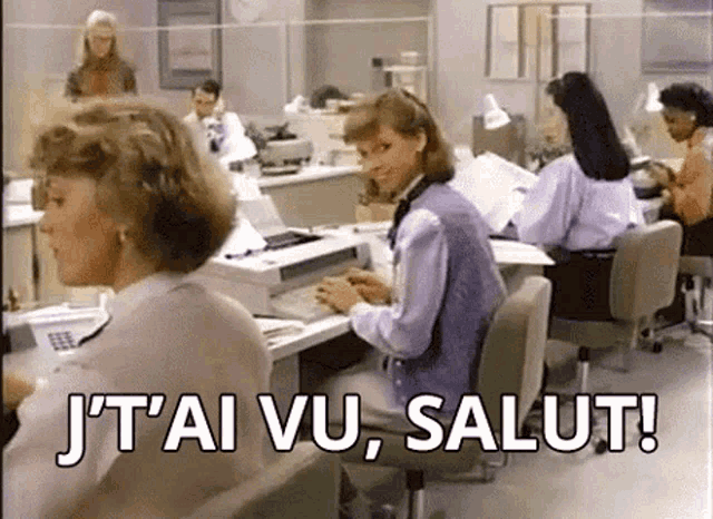 a group of women sitting at desks in an office with the words j'ai vu salut
