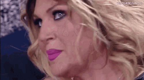 a close up of a woman 's face with a purple lip color .