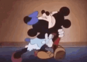 mickey mouse and minnie mouse are hugging each other in a cartoon .
