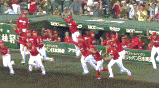 a group of baseball players are running towards a dugout that says ucc