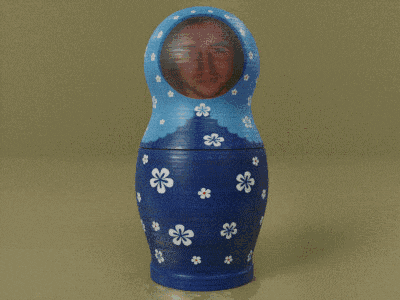 a blue green and orange matryoshka doll with a man 's face on it